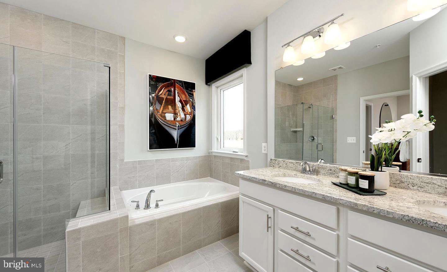 3466 Watershed Boulevard Laurel, MD 20724 - Photo 14 of 18 a bathroom with a tub a sink and mirror