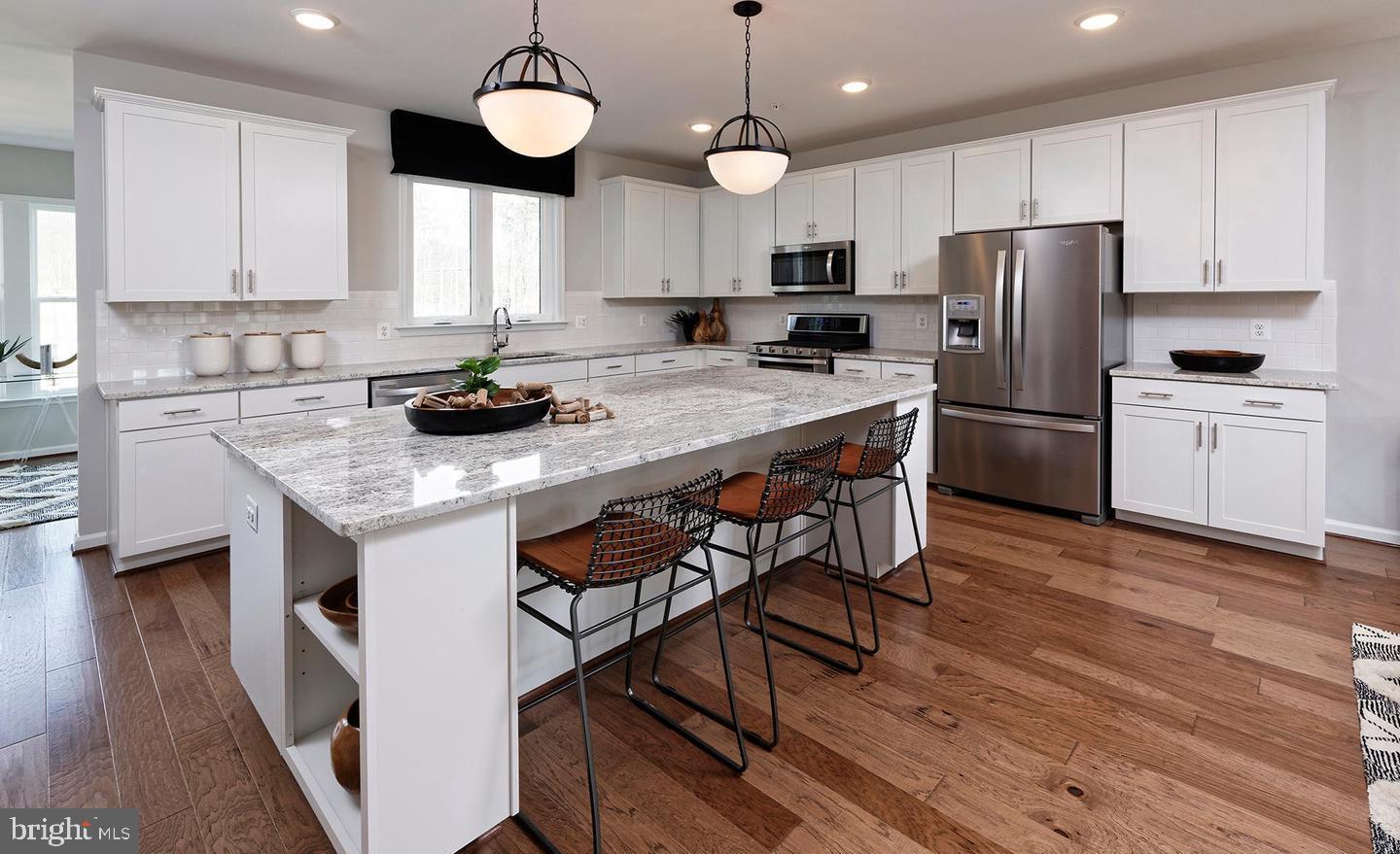 3466 Watershed Boulevard Laurel, MD 20724 - Photo 7 of 18 a kitchen with stainless steel appliances granite countertop a stove a refrigerator a sink a stove and white cabinets with wooden floor