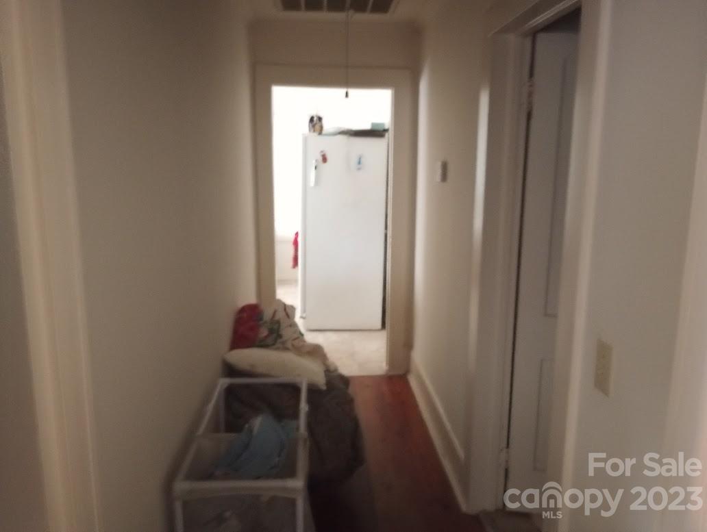 116 Flint Hill Church Road Boiling Springs, NC 28152 - Photo 10 of 18 a view of a hallway with wooden floor and a cabinet