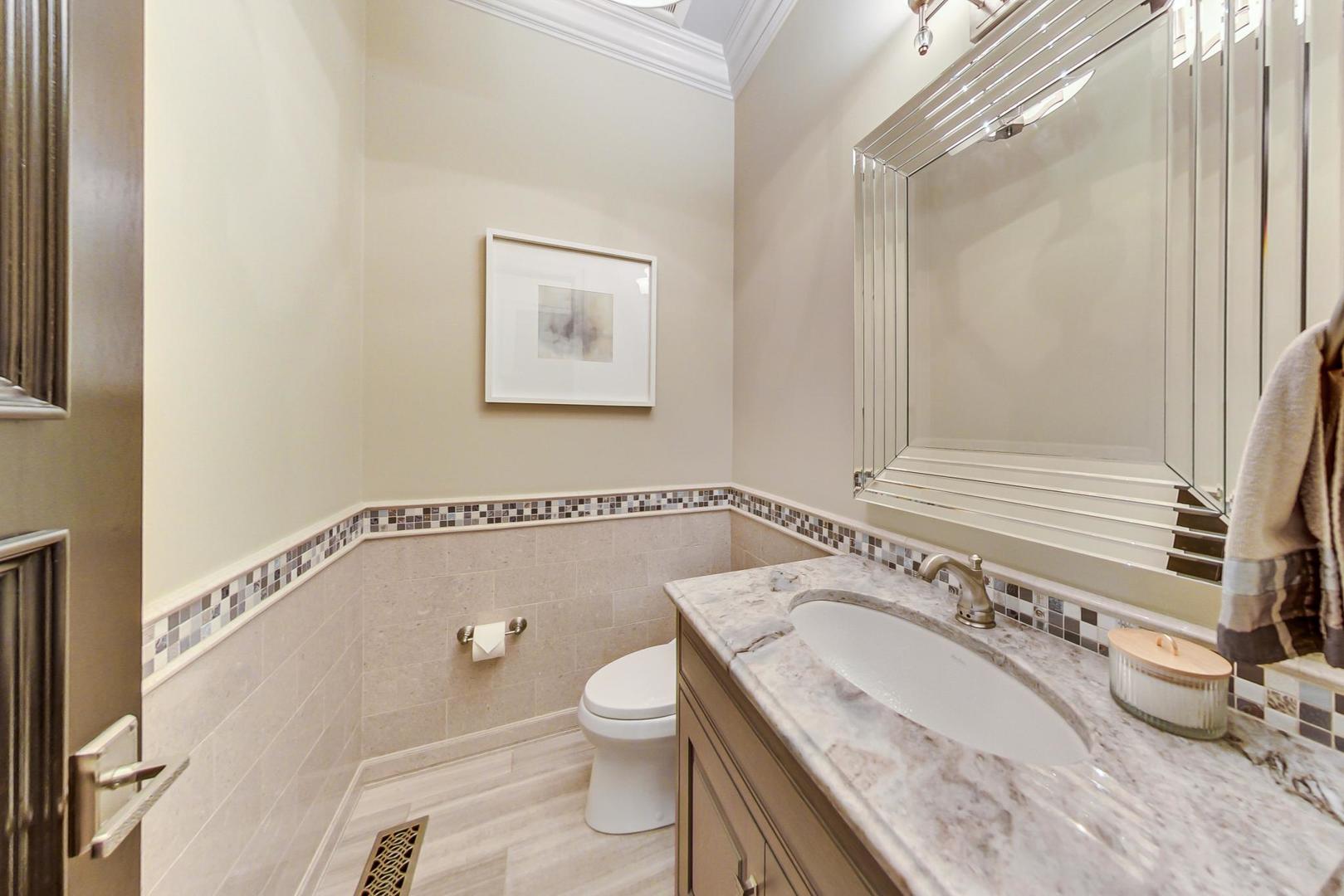 6679 Lee Court Burr Ridge, IL 60527 - Photo 29 of 98 a bathroom with a granite countertop sink a toilet and shower