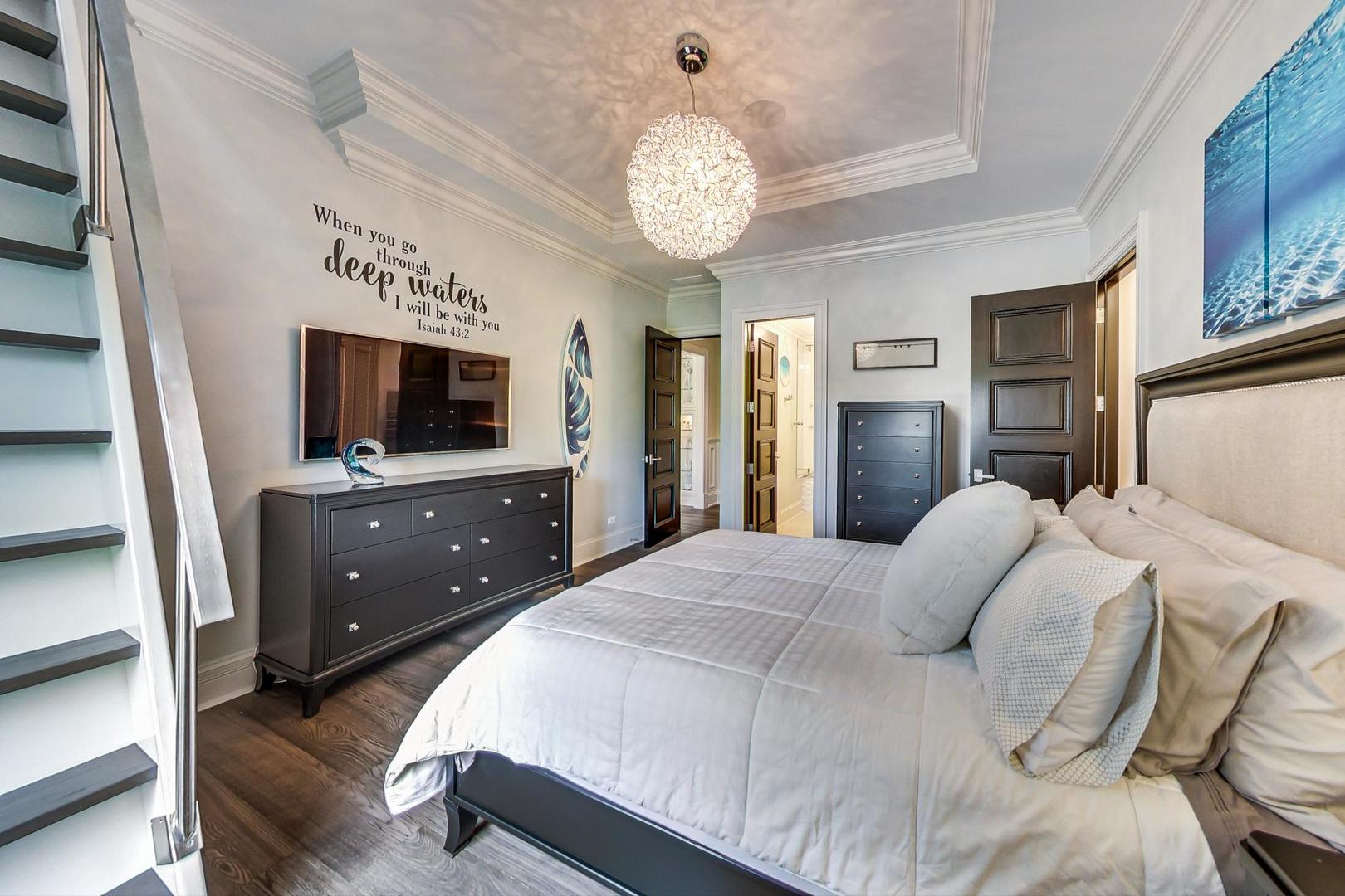 6679 Lee Court Burr Ridge, IL 60527 - Photo 42 of 98 a spacious bedroom with a bed and a flat screen tv