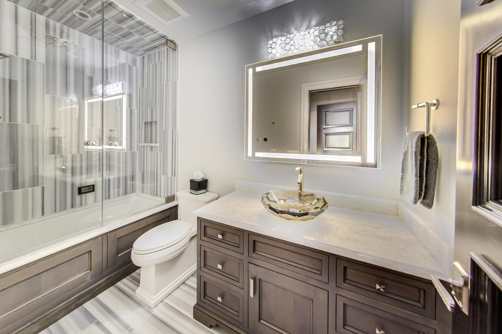 6679 Lee Court Burr Ridge, IL 60527 - Photo 61 of 98 a bathroom with a granite countertop sink toilet a mirror and shower