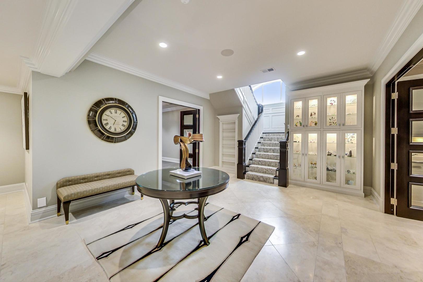 6679 Lee Court Burr Ridge, IL 60527 - Photo 63 of 98 a living room with furniture and a clock