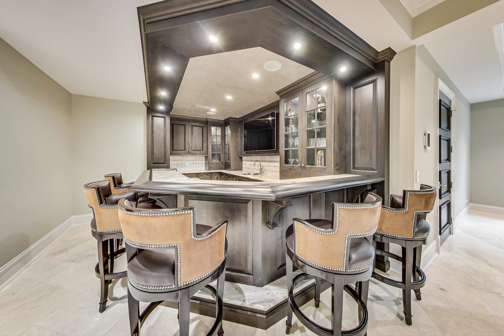 6679 Lee Court Burr Ridge, IL 60527 - Photo 67 of 98 a kitchen with a dining table chairs stainless steel appliances and cabinets