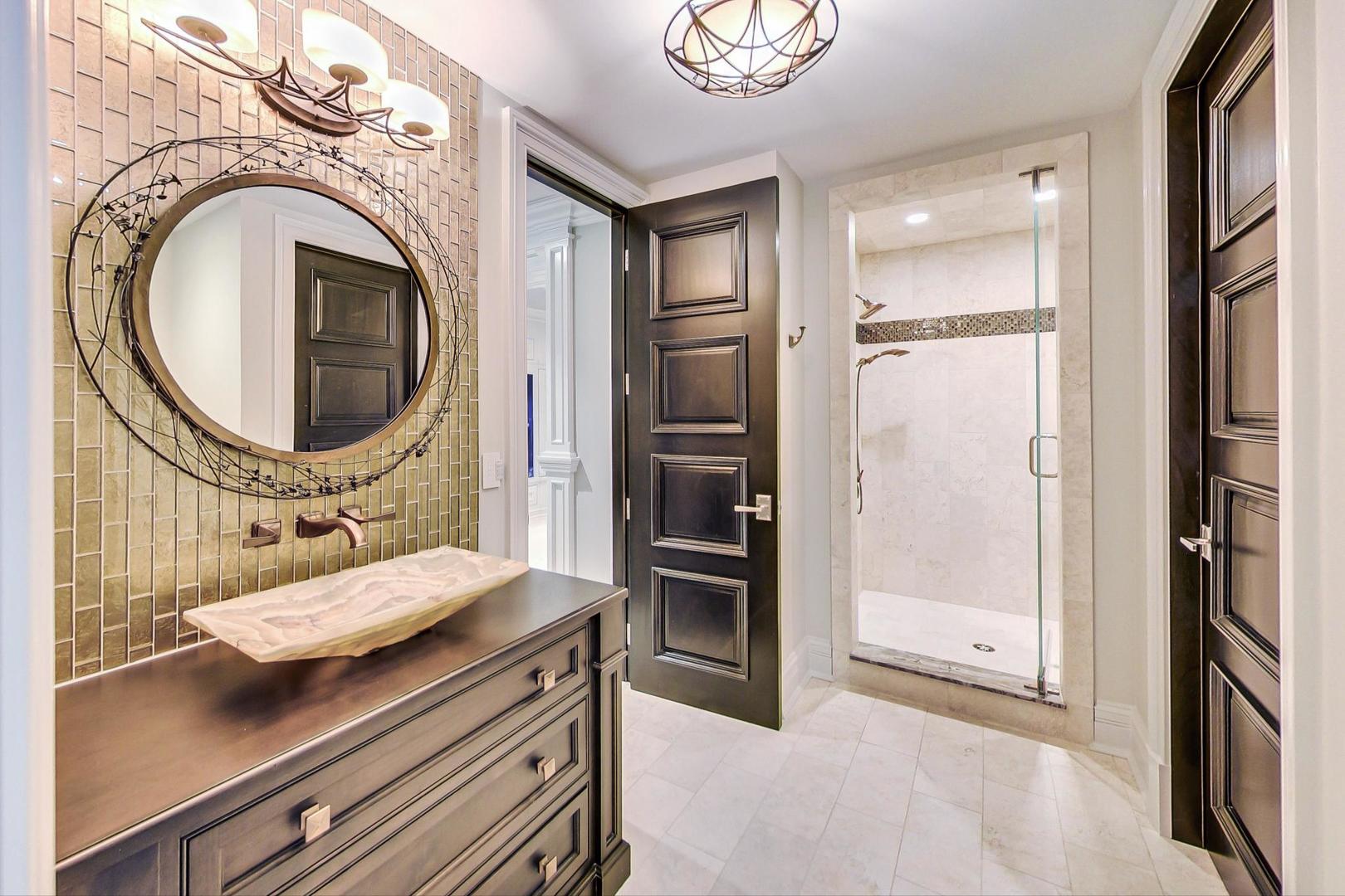 6679 Lee Court Burr Ridge, IL 60527 - Photo 75 of 98 a bathroom with a sink a mirror and a shower