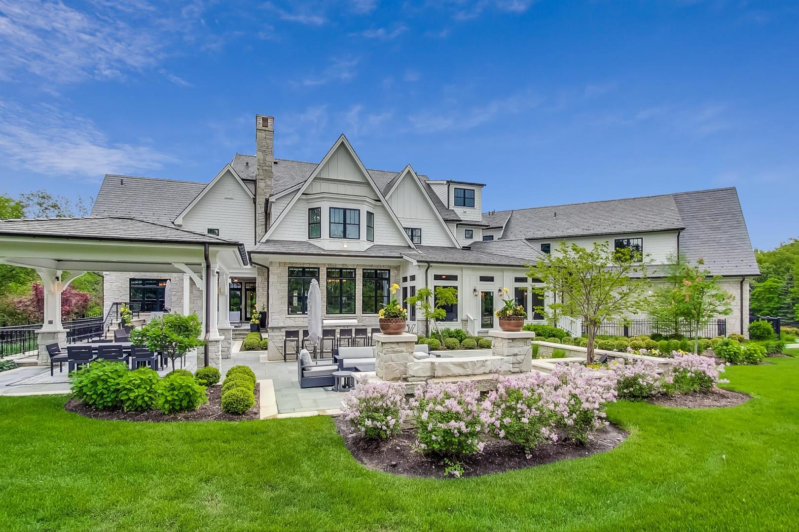 6679 Lee Court Burr Ridge, IL 60527 - Photo 85 of 98 a front view of a house with a garden and plants
