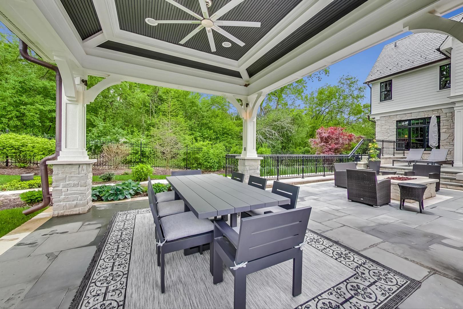 6679 Lee Court Burr Ridge, IL 60527 - Photo 88 of 98 a view of a patio with table and chairs potted plants with wooden floor and floor to ceiling window