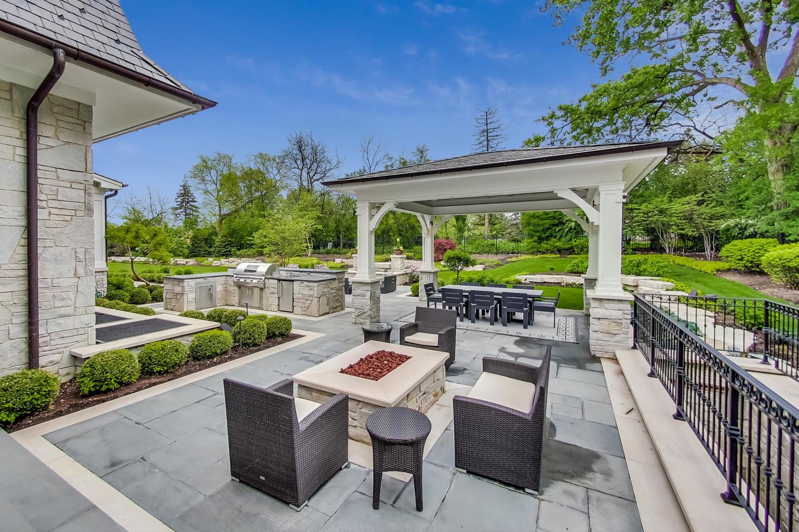 6679 Lee Court Burr Ridge, IL 60527 - Photo 89 of 98 a view of a patio with couches chairs potted plants and a big yard