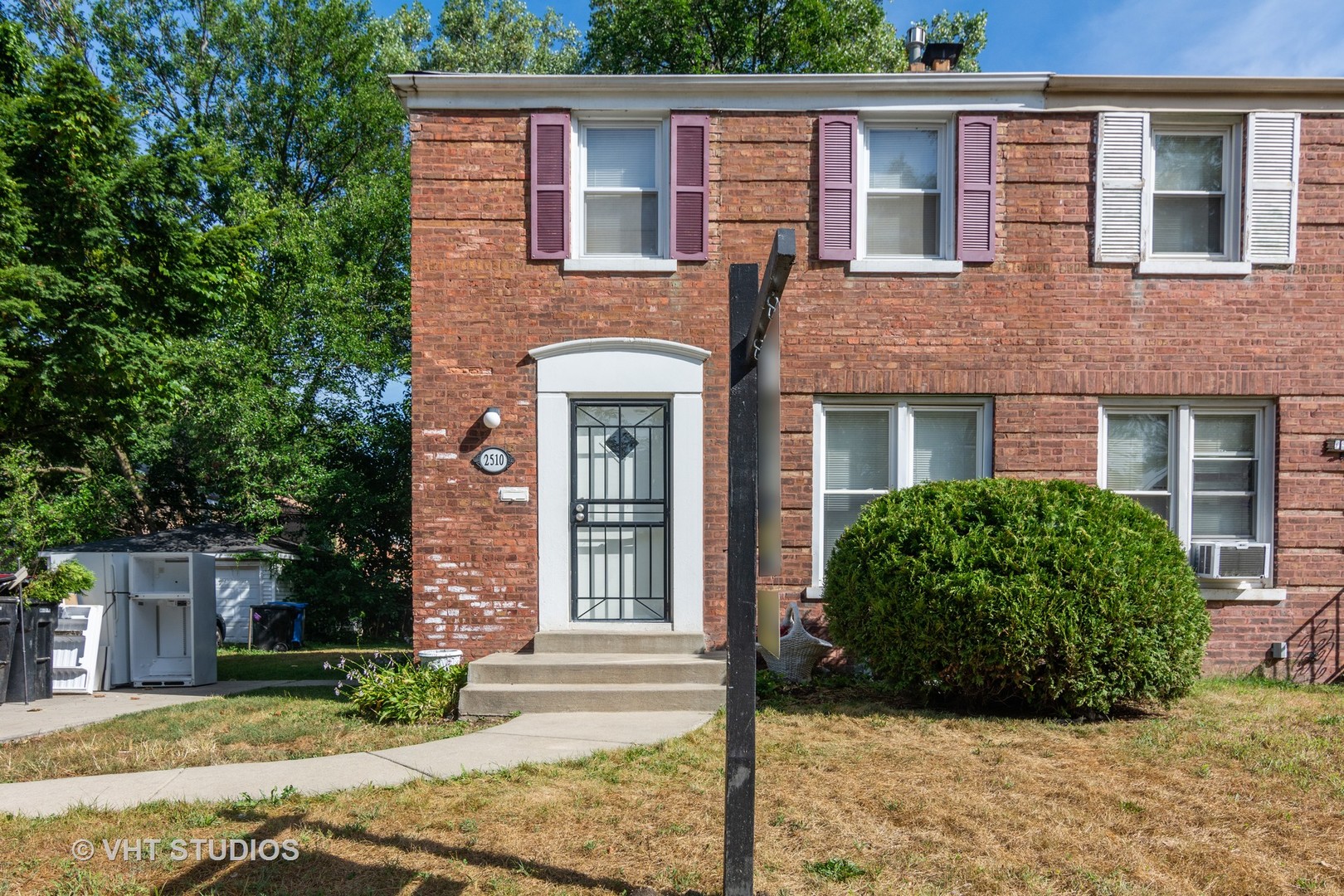 2510 East 96th Street Chicago, IL 60617 - Photo 1 of 13 a view of a brick house with large windows and a tree