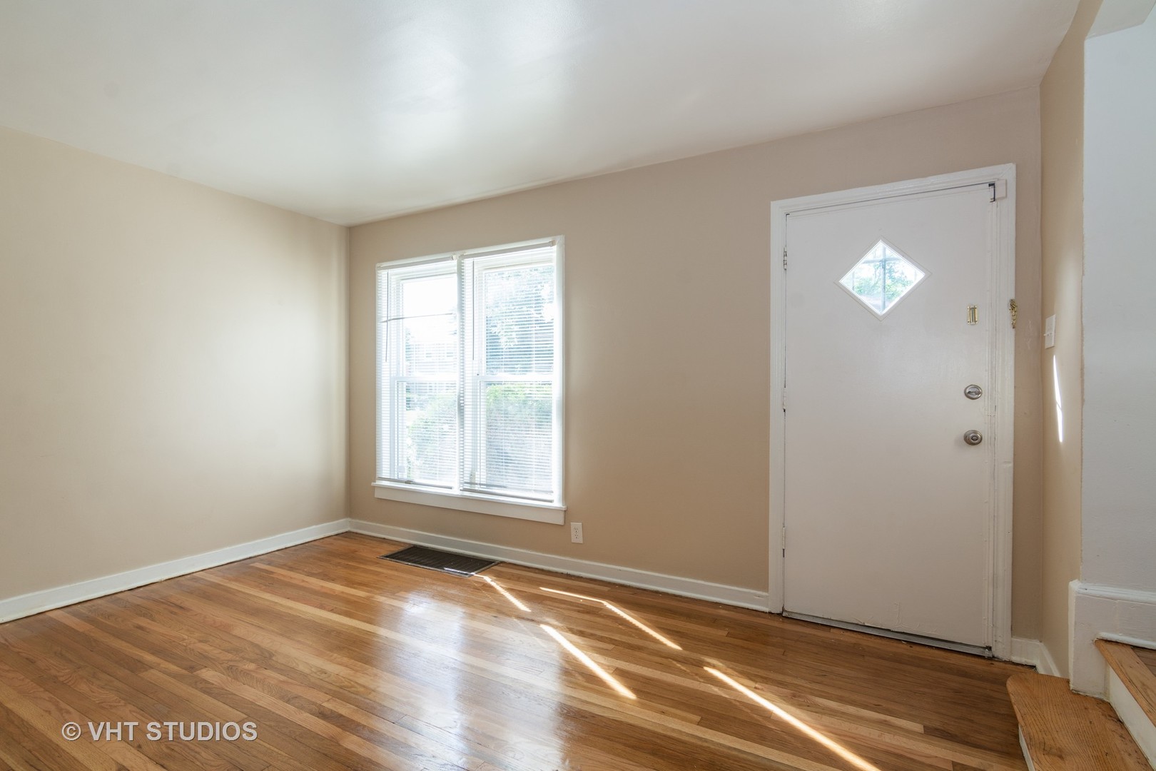 2510 East 96th Street Chicago, IL 60617 - Photo 3 of 13 an empty room with wooden floor and windows