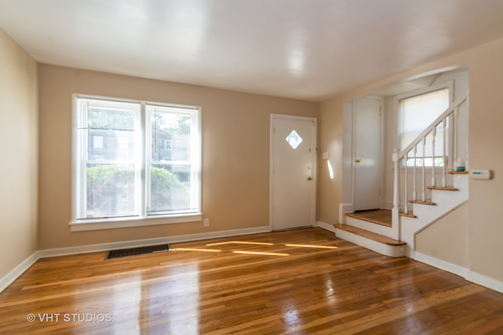 2510 East 96th Street Chicago, IL 60617 - Photo 5 of 13 a view of an empty room with wooden floor and a window