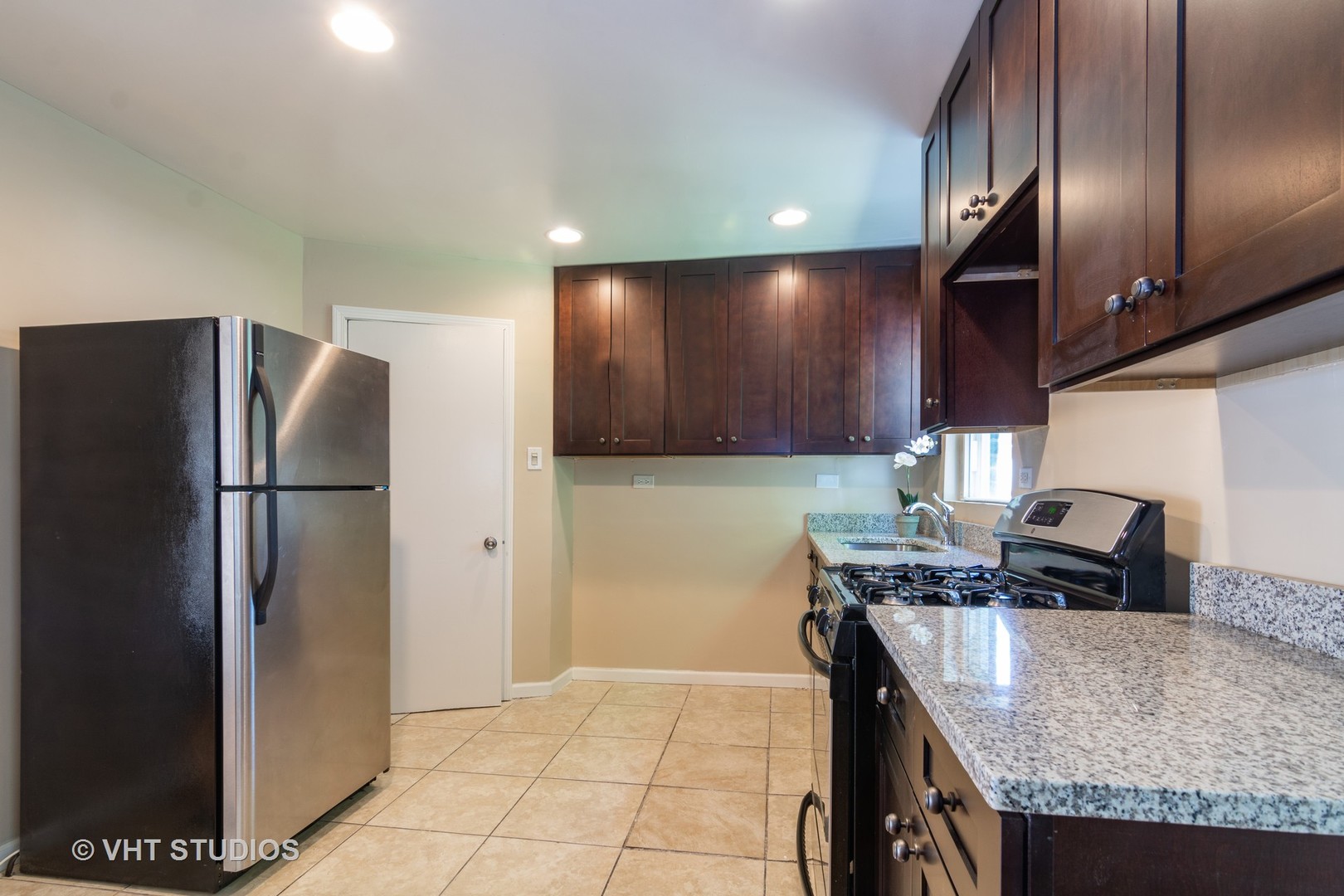 2510 East 96th Street Chicago, IL 60617 - Photo 6 of 13 a kitchen with stainless steel appliances granite countertop a refrigerator a stove and a sink