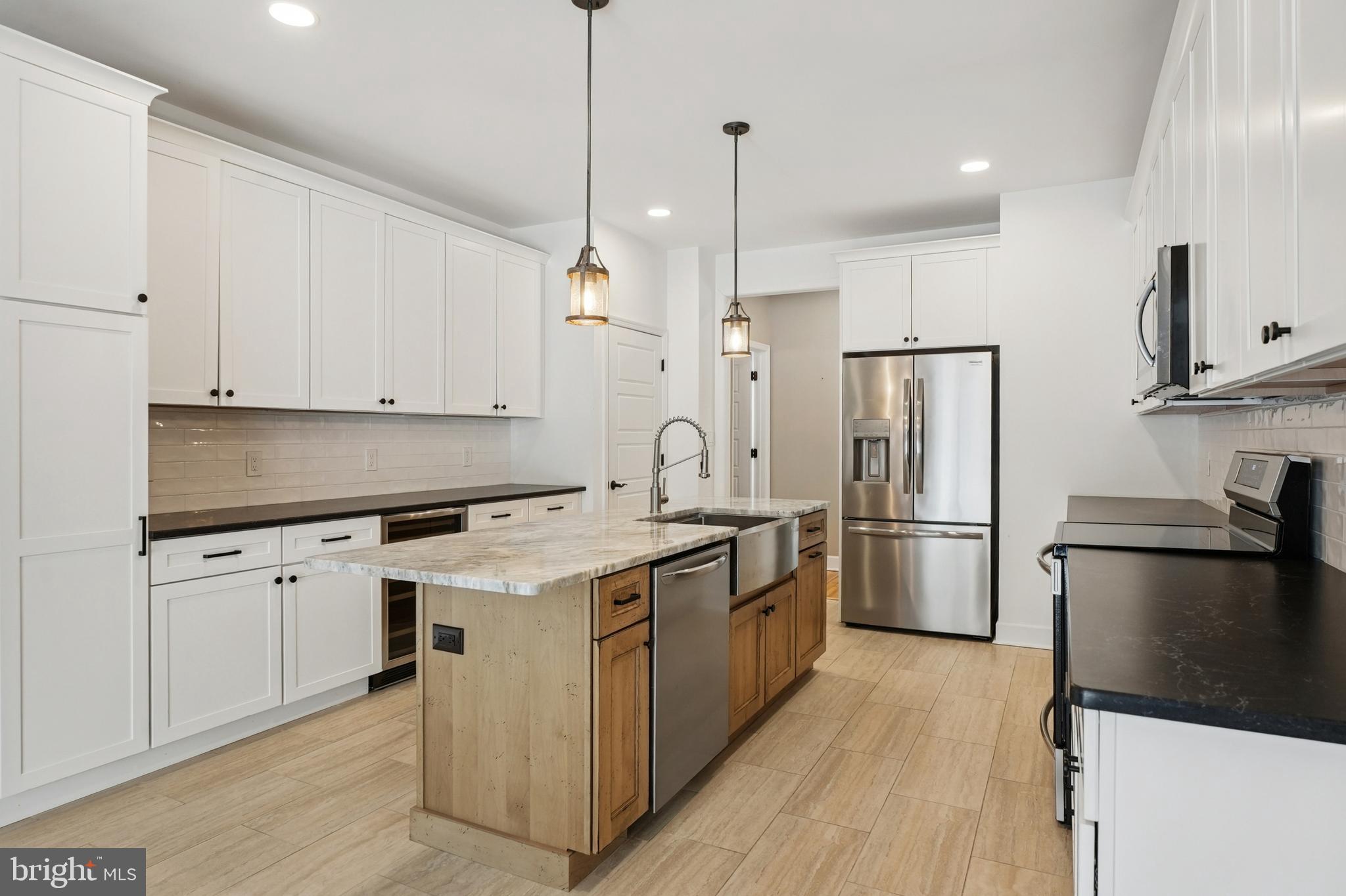 750 Maple Avenue Southampton, NJ 08088 - Photo 13 of 52 a kitchen with stainless steel appliances a stove a sink a refrigerator and white cabinets