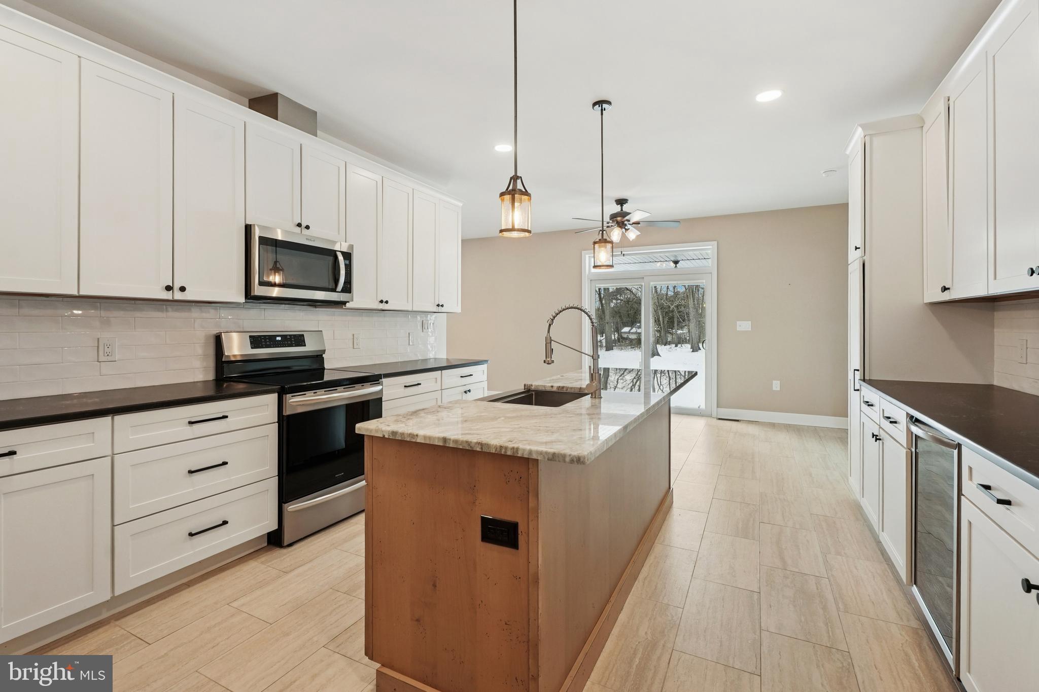 750 Maple Avenue Southampton, NJ 08088 - Photo 14 of 52 a kitchen with stainless steel appliances granite countertop a stove a sink and a refrigerator