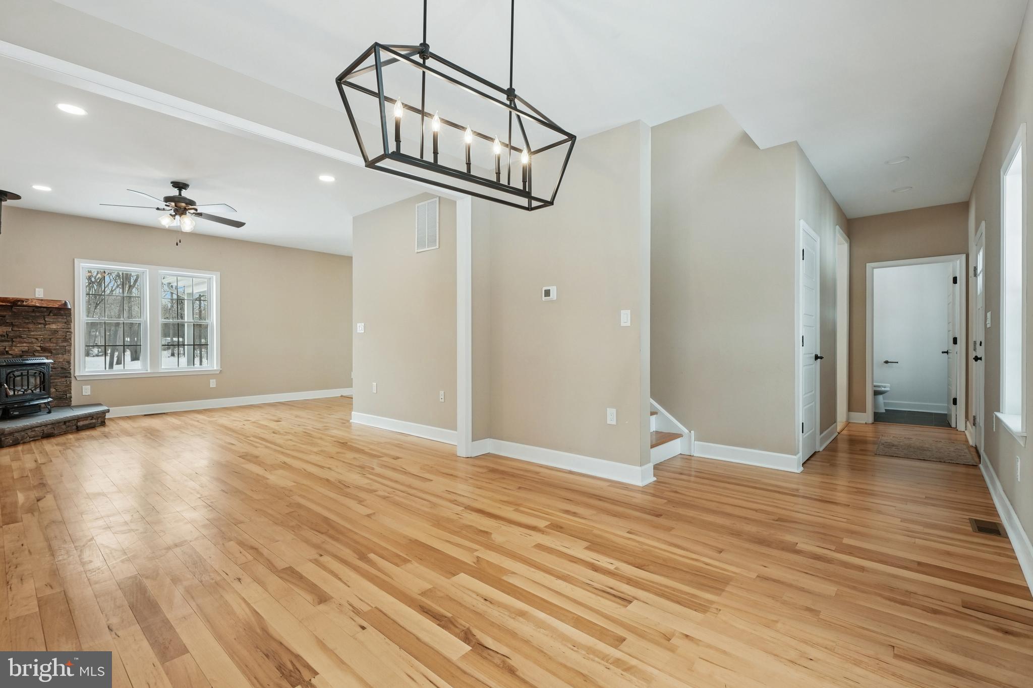 750 Maple Avenue Southampton, NJ 08088 - Photo 16 of 52 a view of an empty room with wooden floor windows and a chandelier