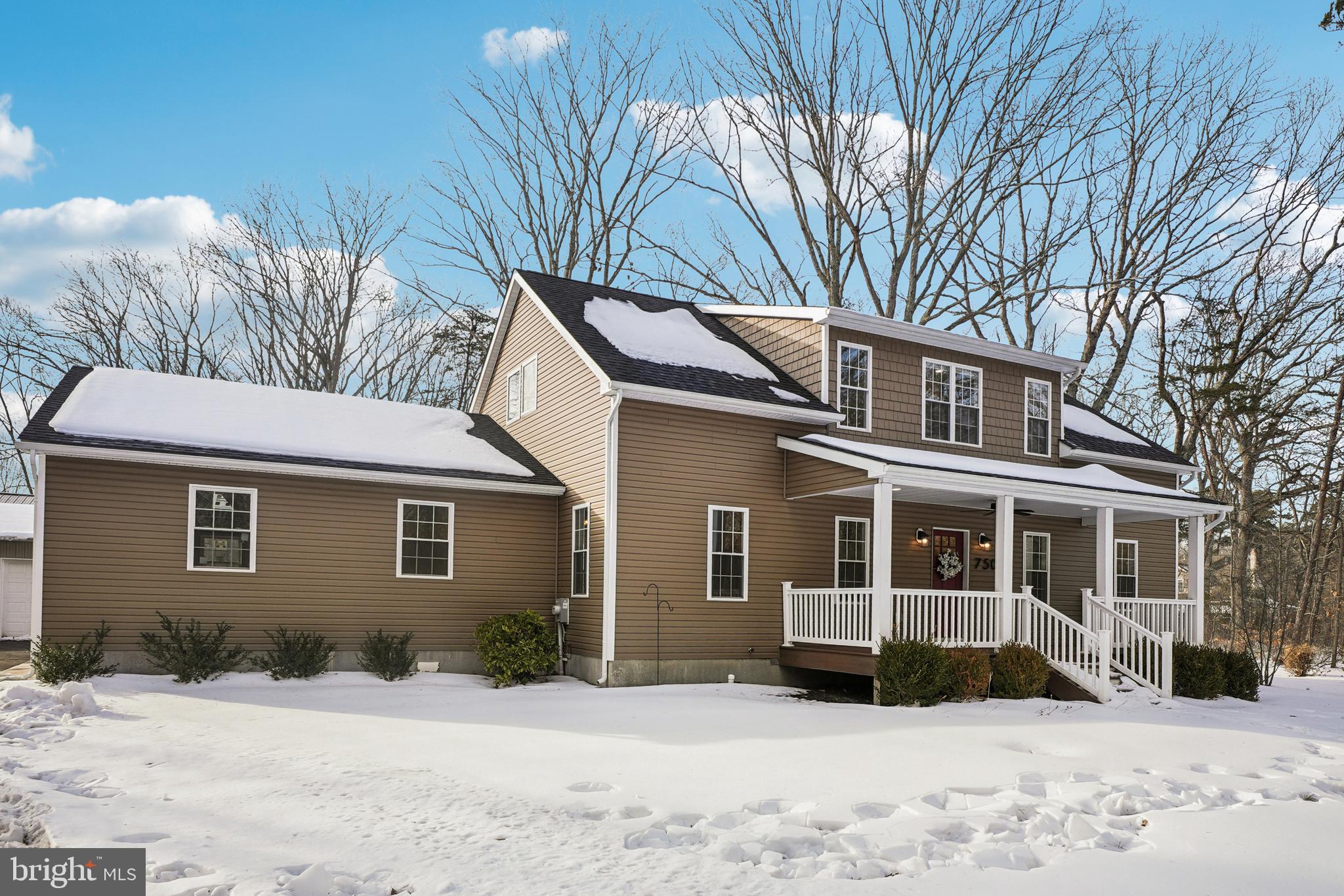 750 Maple Avenue Southampton, NJ 08088 - Photo 2 of 52 a front view of a house with a yard covered in snow