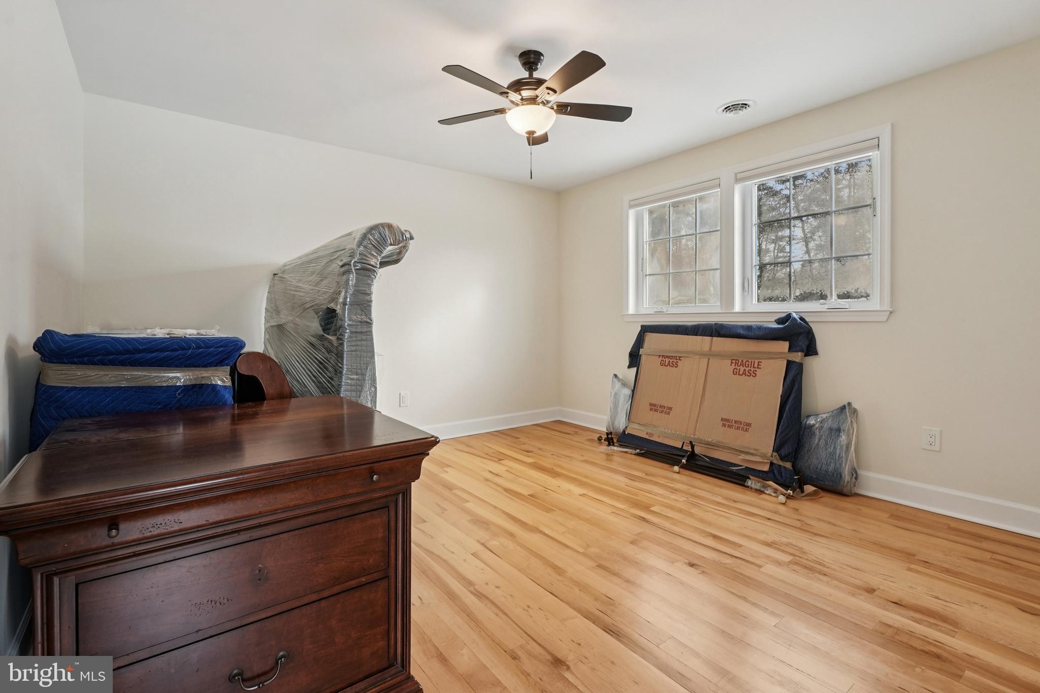 750 Maple Avenue Southampton, NJ 08088 - Photo 25 of 52 a bedroom with a bed and wooden floor