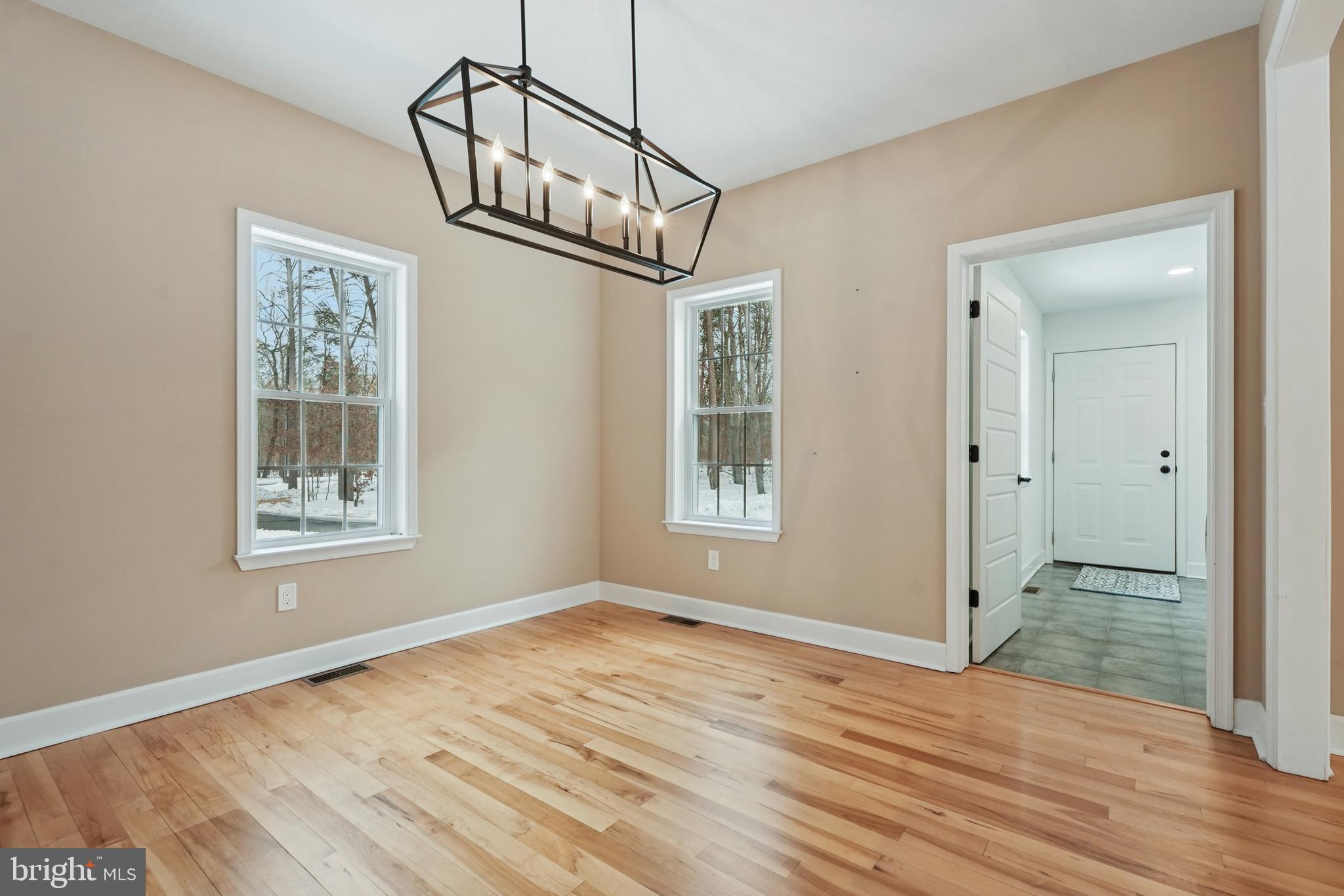 750 Maple Avenue Southampton, NJ 08088 - Photo 7 of 52 a view of an empty room with wooden floor and a window