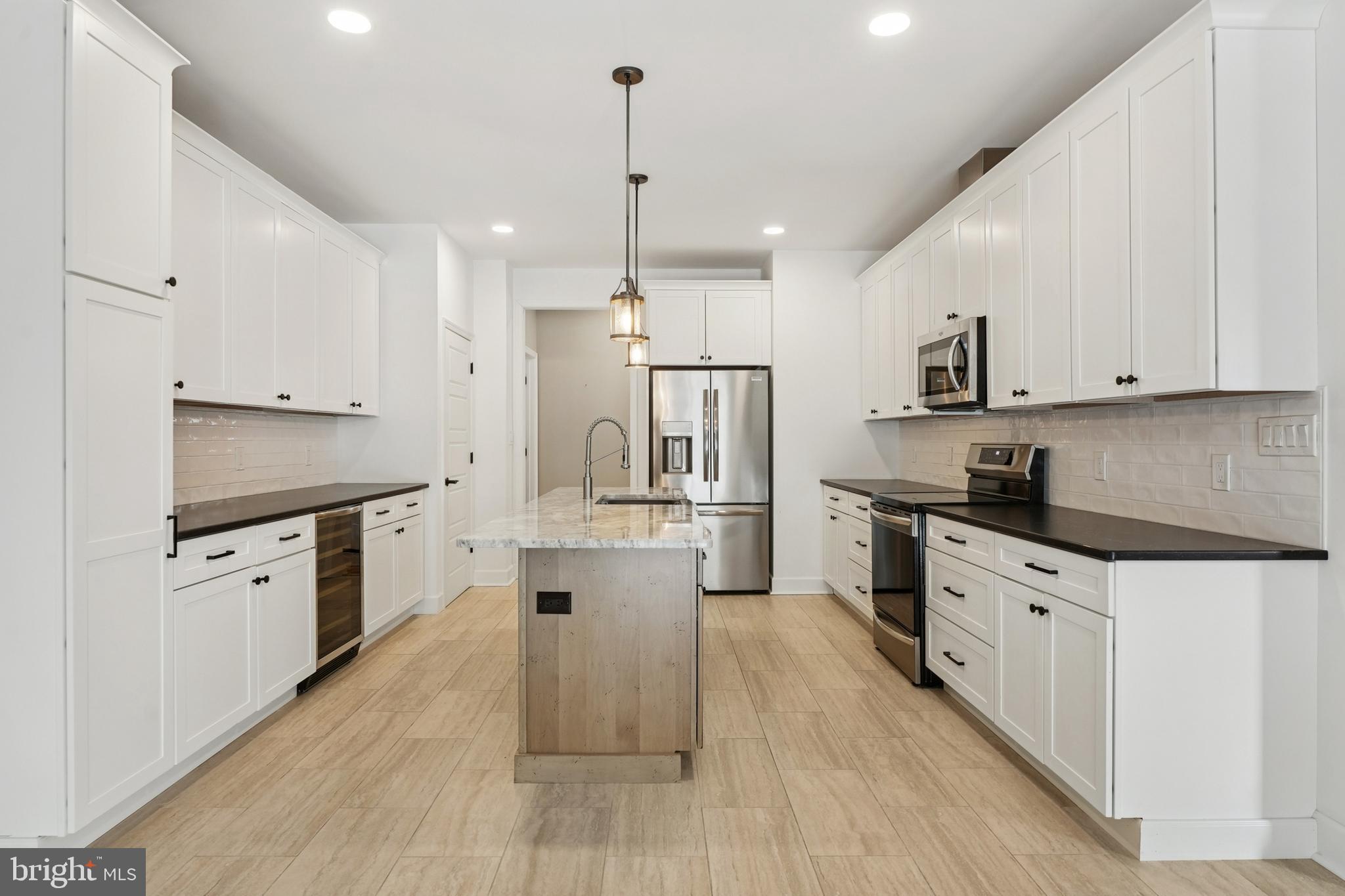 750 Maple Avenue Southampton, NJ 08088 - Photo 10 of 52 a large kitchen with stainless steel appliances sink a stove and white cabinets