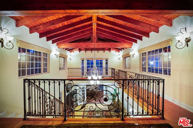 a view of a patio with table and chairs under an umbrella with wooden floor