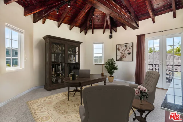 a kitchen with stainless steel appliances kitchen island granite countertop a sink and a refrigerator