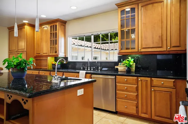 a spacious bedroom with a large bed and a chandelier