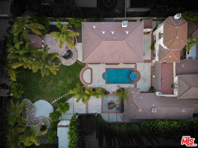 an aerial view of a house with a yard