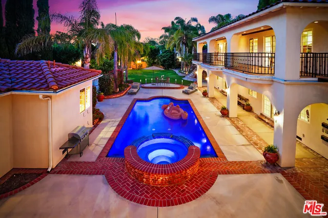 a view of a swimming pool with an outdoor seating