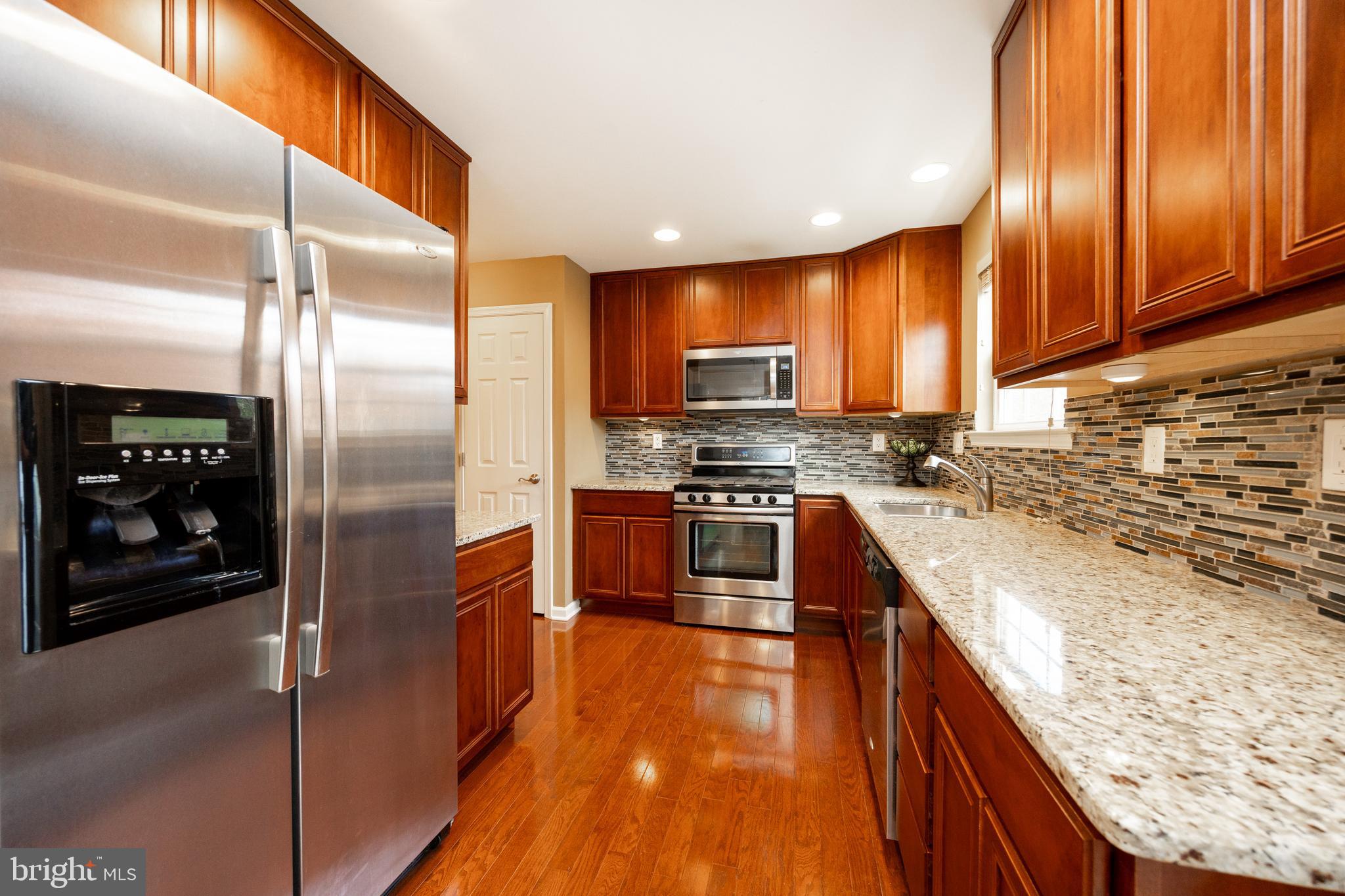 19 Granite Lane, Unit 4 Chester Springs, PA 19425 - Photo 17 of 45 a kitchen with stainless steel appliances granite countertop a refrigerator a stove and a sink