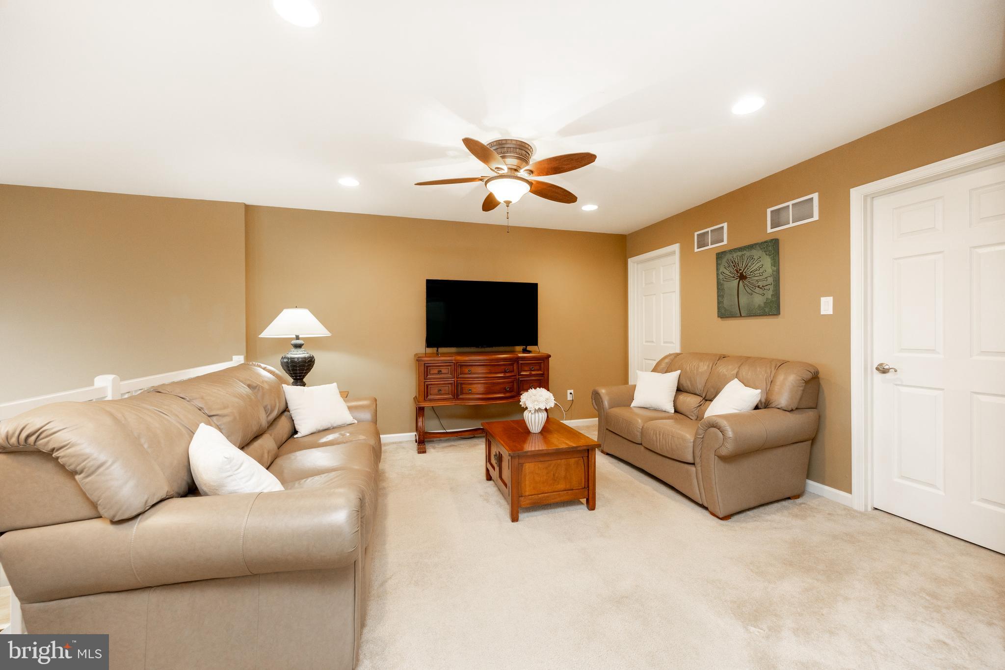 19 Granite Lane, Unit 4 Chester Springs, PA 19425 - Photo 26 of 45 a living room with furniture and a flat screen tv