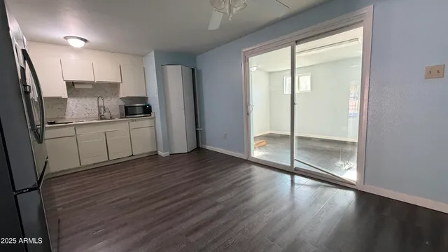 a kitchen with stainless steel appliances a refrigerator and wooden floor