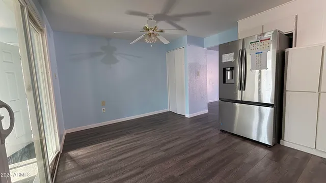 a kitchen with stainless steel appliances a refrigerator and a hard wood floor