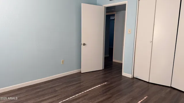 a view of a room with wooden floor