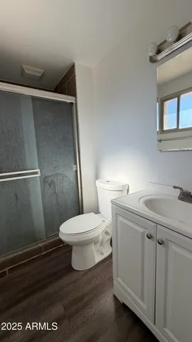 a bathroom with a toilet a sink and mirror