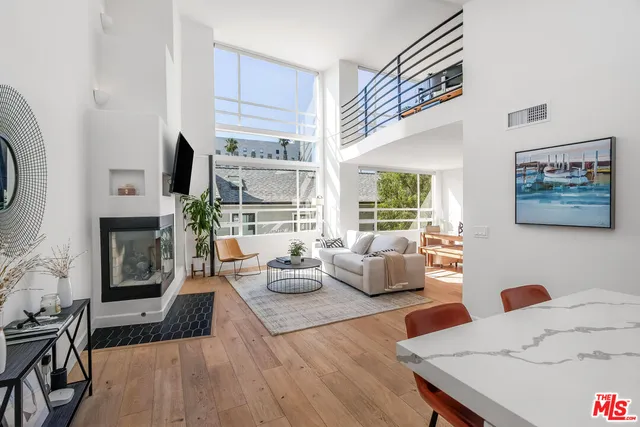 a living room with fireplace furniture and a wooden floor