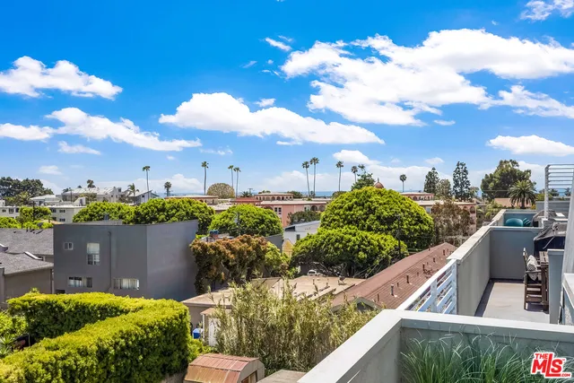 a view of a chairs and table in the backyard