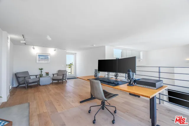 a workspace with furniture and a wooden floor