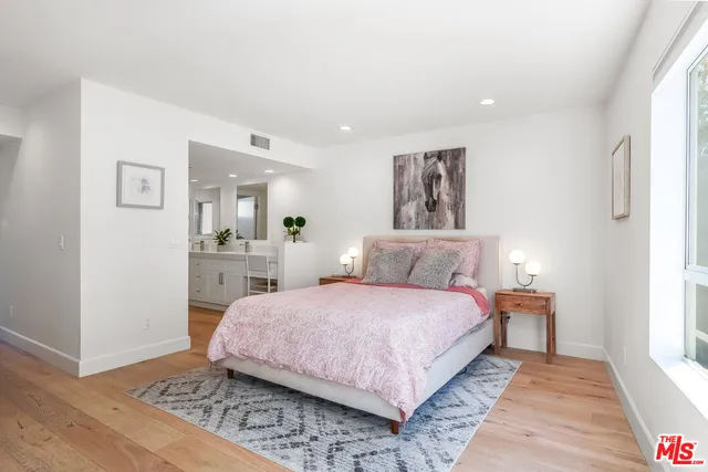 a bedroom with a large bed and a couch