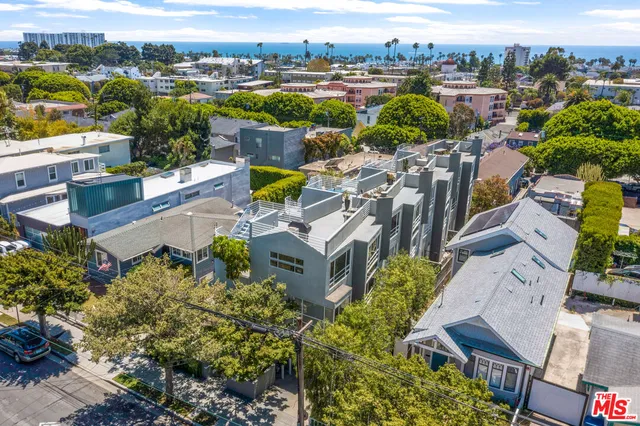 an aerial view of a house with a swimming pool a yard and outdoor seating