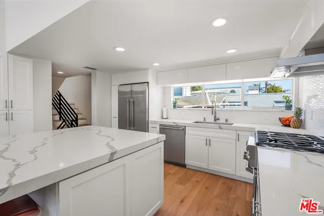 a kitchen that has a sink and a stove in it