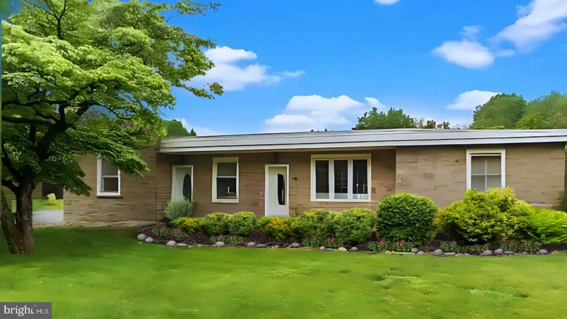 a front view of a house with a garden