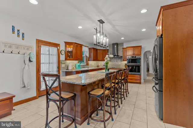 a kitchen with granite countertop stainless steel appliances and counter space