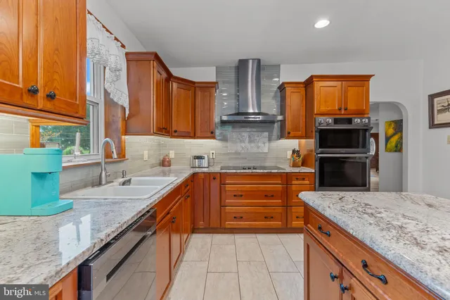 a kitchen with stainless steel appliances granite countertop a sink and cabinets