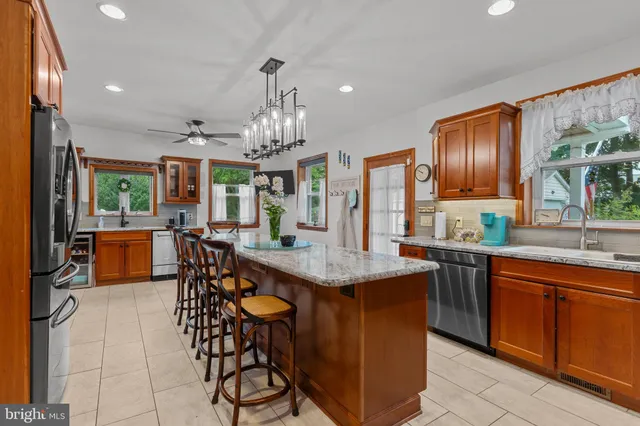 a kitchen with stainless steel appliances granite countertop a sink and cabinets