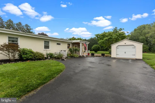 a view of a house with a yard and a garage