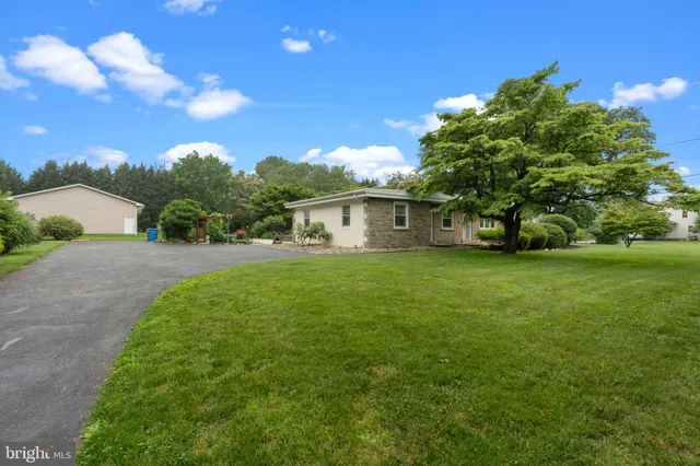 a view of a backyard with sitting area