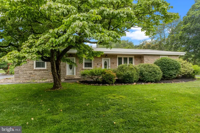 a view of a backyard with sitting area