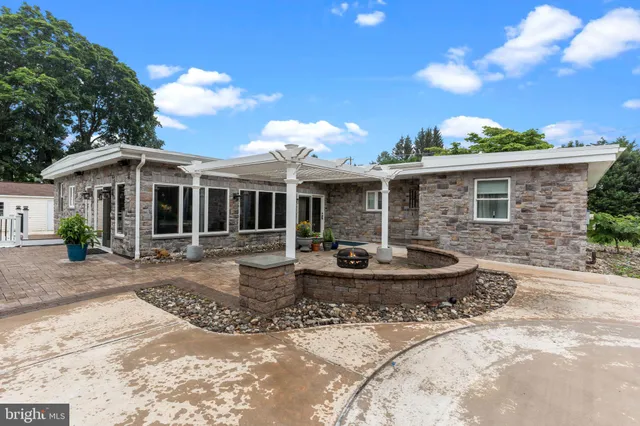 a view of a grassy field with trees in the background
