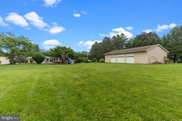 an aerial view of a house with a yard and lake view