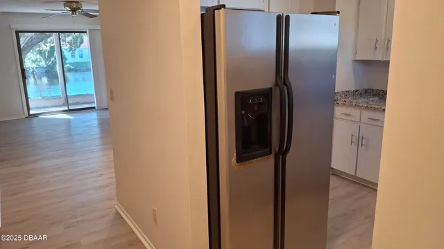 a view of a refrigerator in kitchen and wooden floor